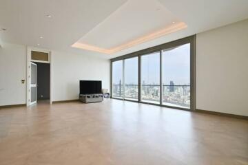 Spacious living room with large windows and city view