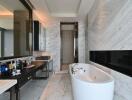 Luxury modern bathroom with marble walls, a freestanding bathtub, and a large mirror