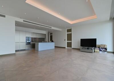 Modern living room with large floor space, TV and kitchen area