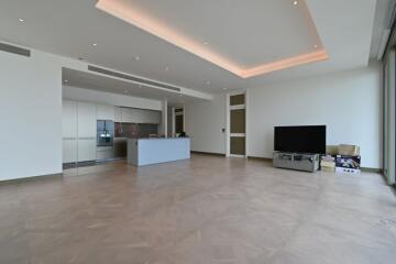 Modern living room with large floor space, TV and kitchen area