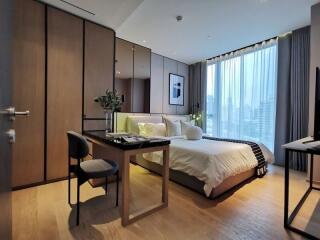 Modern bedroom with large windows and stylish furniture