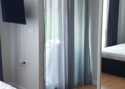 Bedroom with mirrored closet doors, TV, and air conditioning