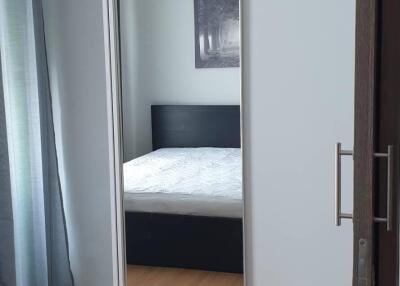 Bedroom with wooden flooring, large wardrobe with mirror, and double bed