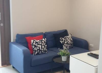 Cozy living room with blue sofa and decor