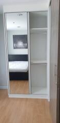 Bedroom with mirrored wardrobe and bed