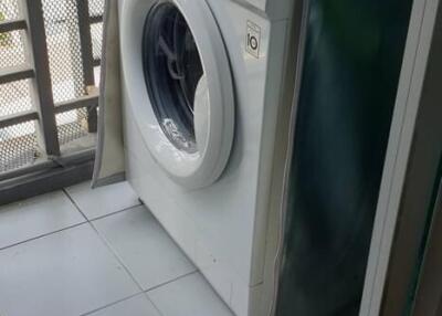 Washing machine in a laundry area with green walls