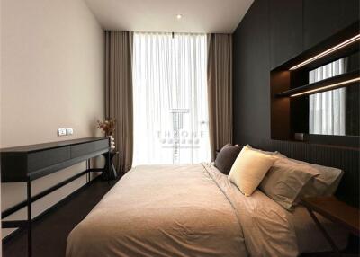 Modern bedroom with a large bed, stylish furniture and natural light.