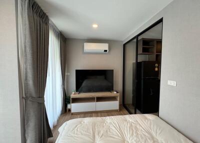 Modern bedroom with TV setup and air conditioning