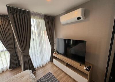 Living room with air conditioner and TV