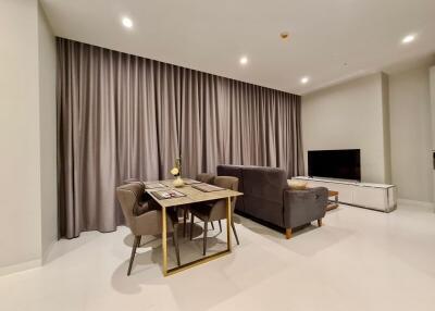 Modern living room with a dining area and TV