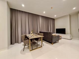 Modern living room with a dining area and TV