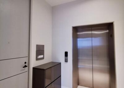 Hallway with elevator and storage unit