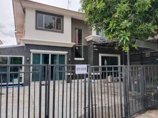 Two-story house with gated driveway