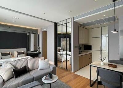 Modern studio apartment with bed, living area, and kitchen