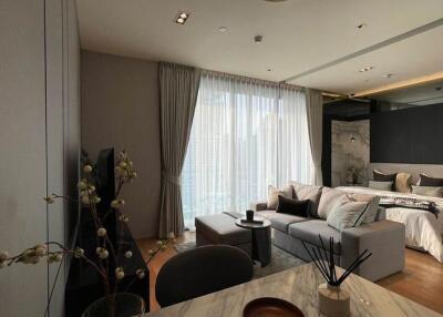 Modern living area with integrated bedroom and large windows
