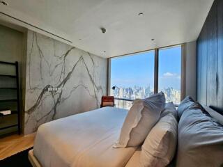 Modern bedroom with large window offering city view