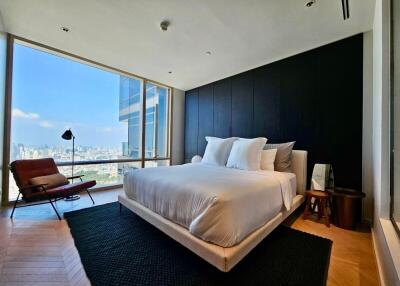 Spacious modern bedroom with large windows and city view