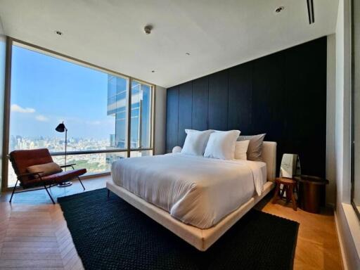 Spacious modern bedroom with large windows and city view