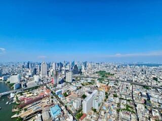 Aerial view of a city with numerous buildings and a river