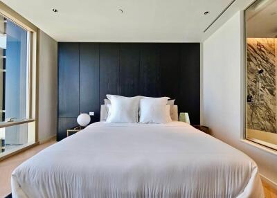Modern bedroom with large windows and black accent wall