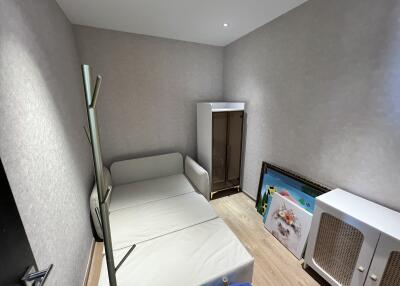 Small bedroom with a folded bed and furniture