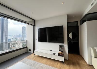 Modern living room with large TV and city view