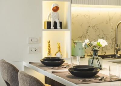 Modern kitchen with decorative shelves and dining area