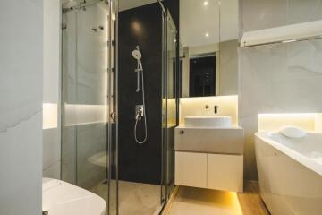 Modern bathroom with glass shower, vanity, and bathtub