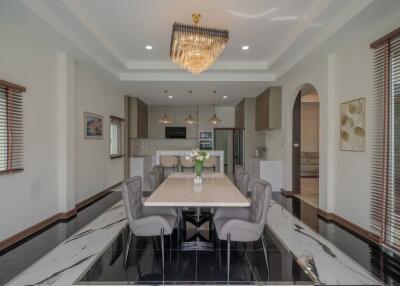 Modern dining room with elegant chandelier and set table