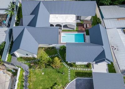 Aerial view of modern residential building with pool
