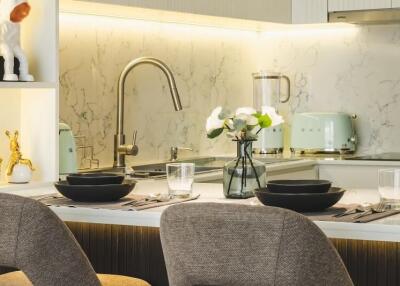 Modern kitchen with marble backsplash and breakfast bar