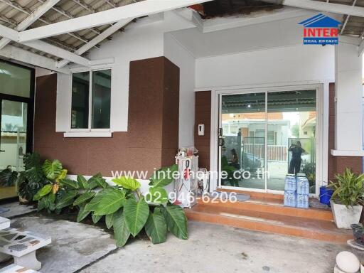 Front view of house with plants and glass door