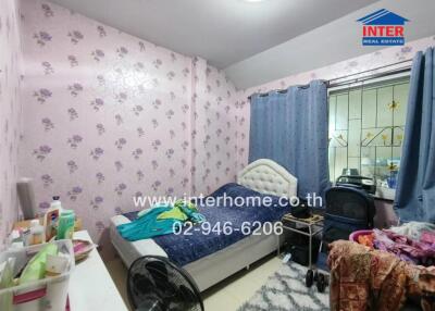 Cozy bedroom with floral wallpaper and a double bed
