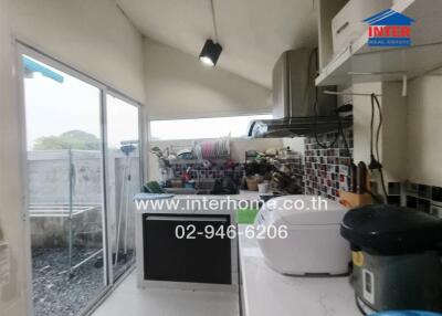 Small kitchen with modern appliances and access to outdoor area