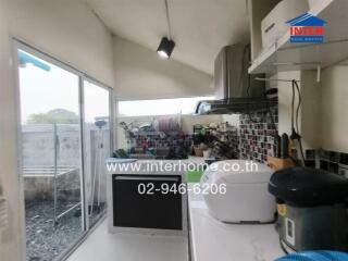Small kitchen with modern appliances and access to outdoor area
