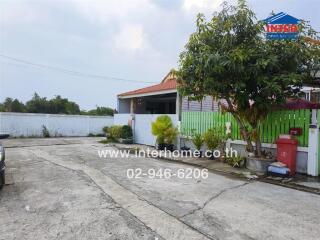 Exterior view of a house with driveway and greenery