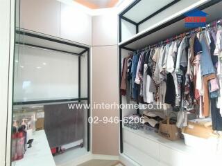 Spacious walk-in closet with ample hanging space and shelves