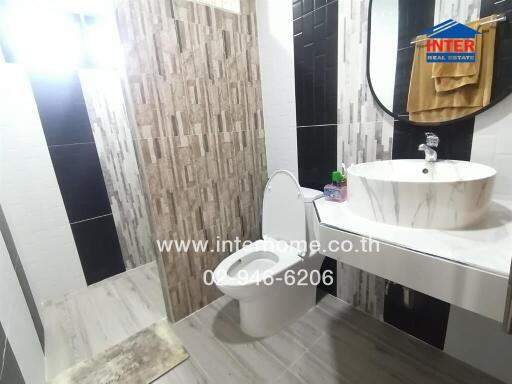 Modern bathroom with neutral tiles and a sink