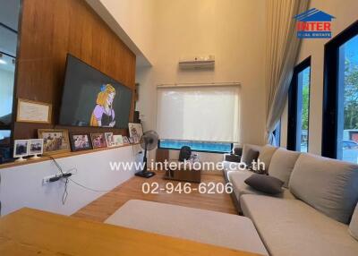 Spacious living room with large TV and comfortable seating