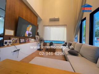 Spacious living room with large TV and comfortable seating