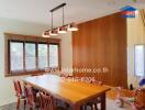 Dining room with wooden table, chairs, and a hanging light fixture