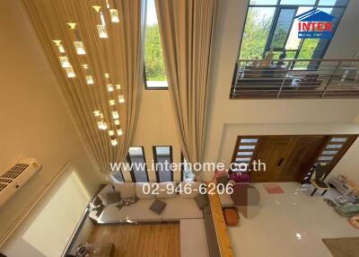 High-ceiling living room with large windows and modern interior