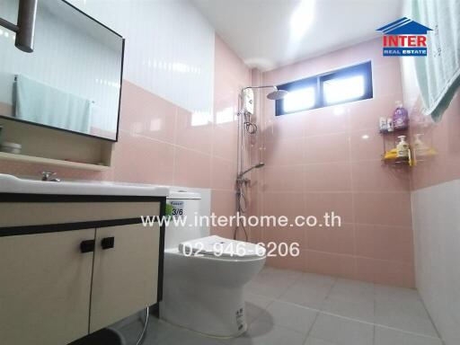 Bathroom with sink, toilet, shower, and mirror