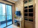 Modern living room with a balcony view, television, and storage unit