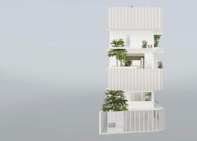Modern multi-story residential building with balconies and greenery