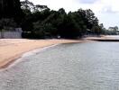 Secluded Beach Area with Nearby Buildings and Trees