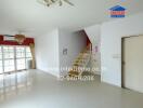 Bright and open main living area with staircase and large windows