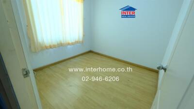 Empty bedroom with wooden floor and window