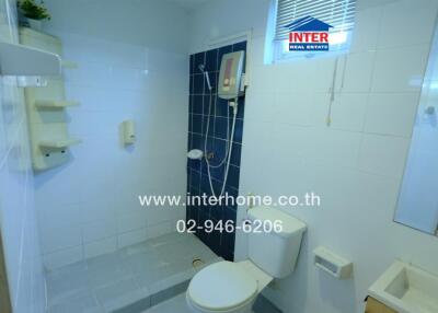 Modern bathroom with fixtures and tiled walls