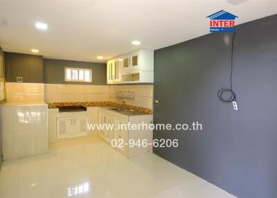 Modern kitchen interior with tiled backsplash and light cabinets